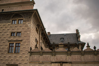 Low angle view of old building against cloudy sky