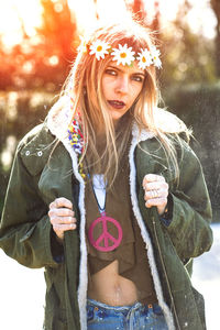 Portrait of young woman wearing tiara standing outdoors