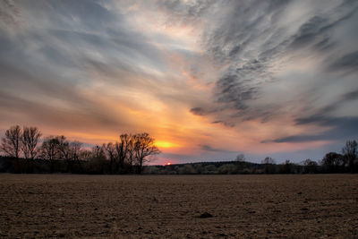 Scenic view of field against sky during sunset