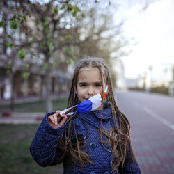 Portrait of girl holding camera