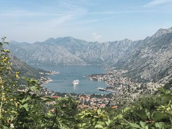 Scenic view of sea and mountains against sky