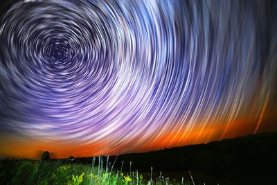 Scenic view of landscape against sky at night