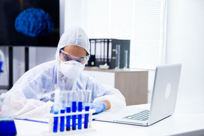 Scientist examining tube in laboratory at hospital
