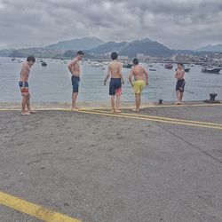 People on beach against sky