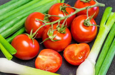 Close-up of cherry tomatoes and scallion on table