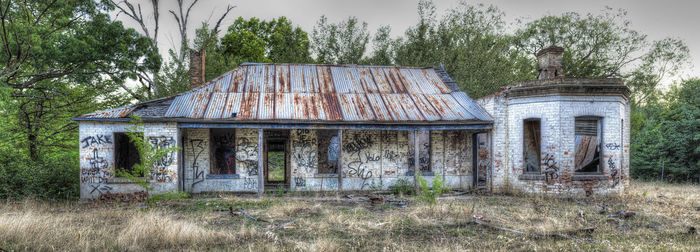 Old house with trees in background