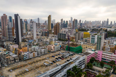 High angle view of modern buildings in city against sky