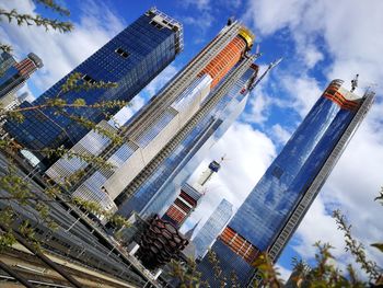 Low angle view of buildings against cloudy sky