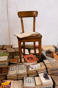 Stack of table and chairs against wall
