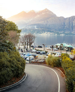 High angle view of road by lake against mountains