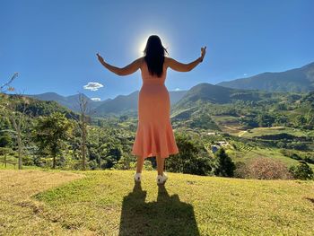 Rear view of woman standing on mountain