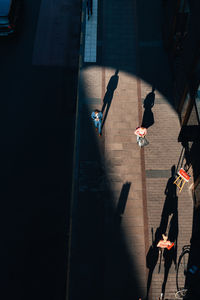 High angle view of people walking on street in city