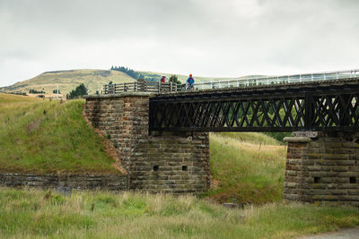 Built structure on landscape against the sky