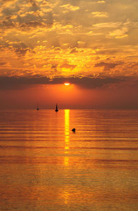 Scenic view of calm sea at sunset