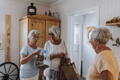 Smiling senior women standing in living room