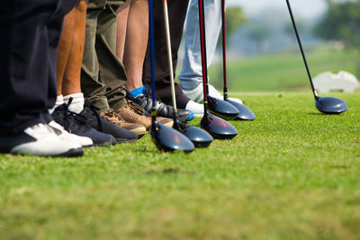 Low section of people standing on golf course