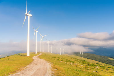 Windmill on field against sky