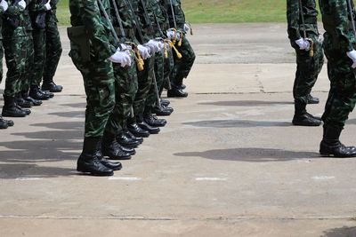 Low section of soldiers walking on street