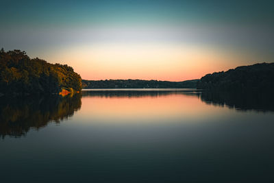 Landscape of peaceful area covered with trees and reflecting in still water