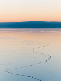 Scenic view of sea against clear sky during sunset