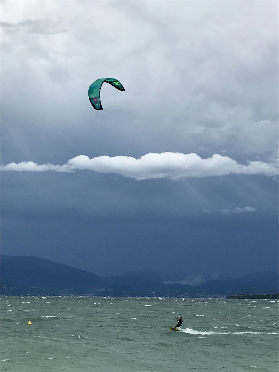 PERSON PARAGLIDING AGAINST SEA