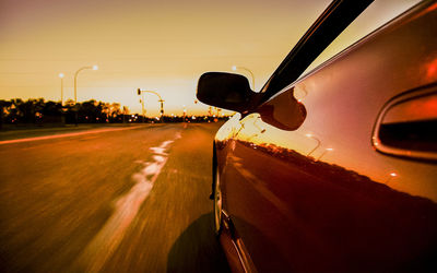 Close-up of car on road against sky