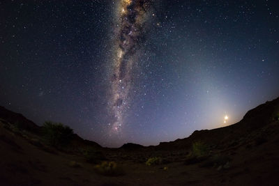 Scenic view of mountains against star field at night