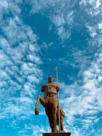 Low angle view of statue against blue sky