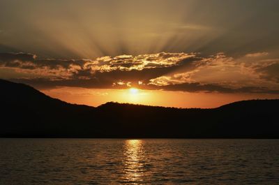 Scenic view of lake at sunset