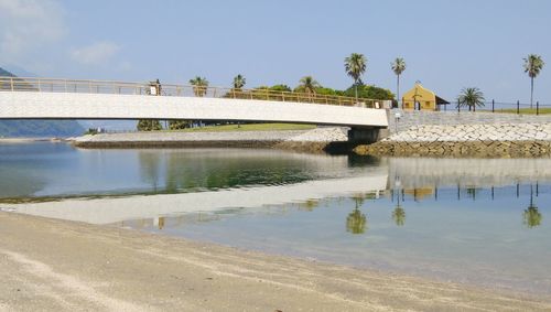 Bridge over river against buildings