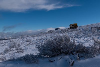 Scenic view of snowcapped landscape against blue sky