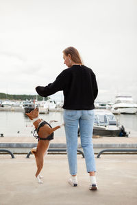 Rear view of woman walking on road