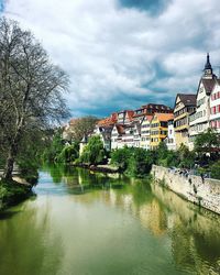 Scenic view of river by trees against sky