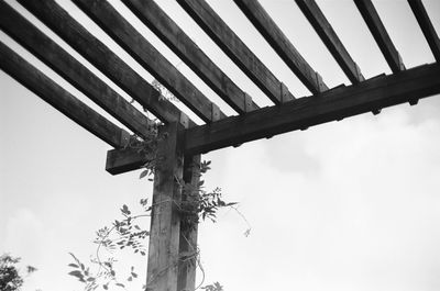 Low angle view of telephone pole against sky