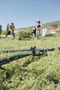 Pipe over grass covered field on sunny day