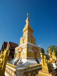 Low angle view of buildings against clear blue sky