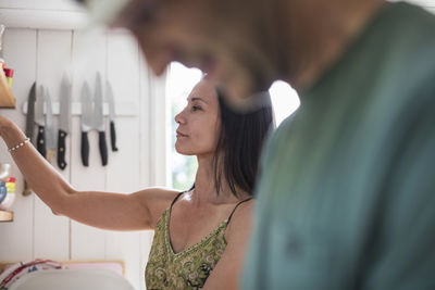 Mature couple working in kitchen at home