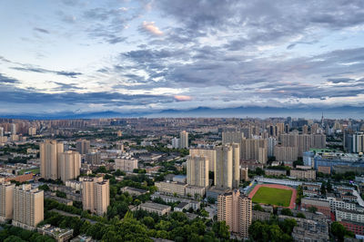 High angle view of modern buildings in city against sky