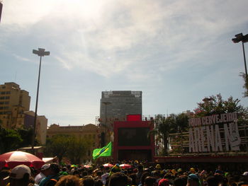 People on street in city against sky