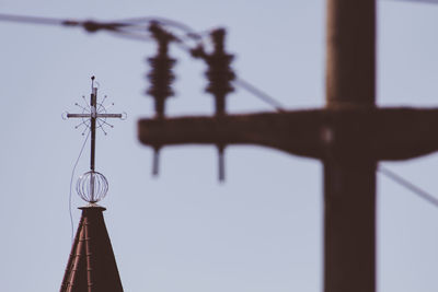 Low angle view of communications tower against sky