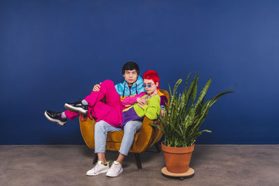 Full length of a boy with toys against blue background