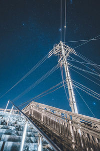 Low angle view of bridge against sky at night
