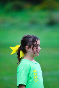 Side view of boy standing on field