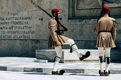 Rear view of people walking on street in winter