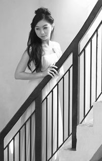 Low angle portrait of young woman on steps