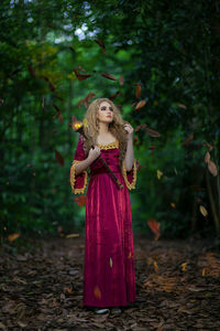 Woman standing by tree