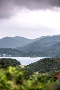 Scenic view of lake and mountains against sky