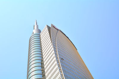 Low angle view of modern building against clear blue sky