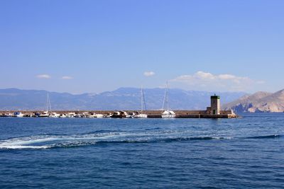 Sailboat on sea against blue sky