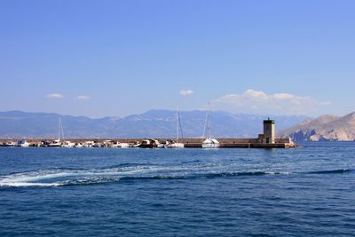 Sailboat on sea against blue sky